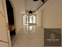 2BR apartment in Al Tallah 2, first tenant, includes hall, majlis, 3 baths, central AC, balcony, bui