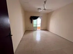 Studio apartment for rent in Ajman, annual rental, with balcony, separate kitchen, and central air c