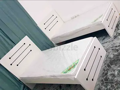Brand New Pair of white single beds with mattresses