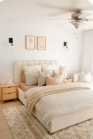 Neutral beige upholstered bed with bedside tables and decor - complete bedroom set look