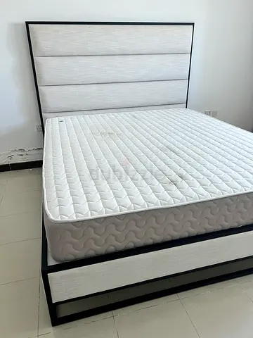 King size bed frame with mattress and padded headboard