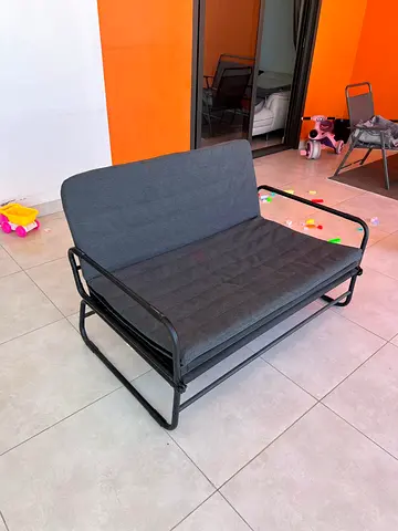Convertible metal frame sofa bed — compact 2-seater, dark grey