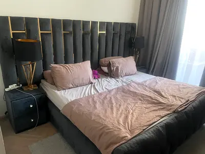 King-size upholstered bed frame with matching bedside cabinets and lamps