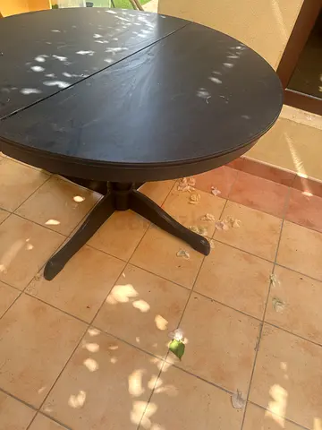 Round dark wood dining table with 4 chairs