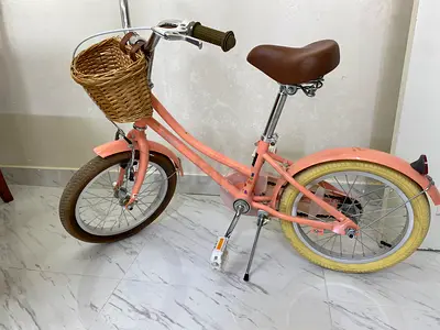 Small pink children’s bicycle with basket — good condition