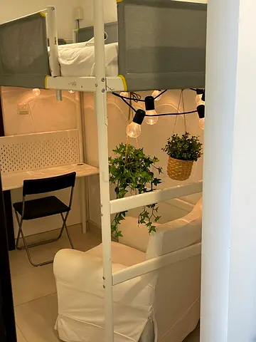 Compact white loft bed with desk area — ideal for studio/child’s room