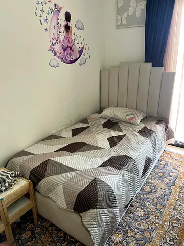 Double upholstered bed with padded headboard - light grey