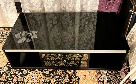 Black glass coffee table with storage drawer