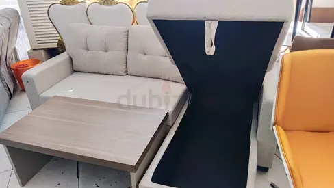 Light grey fabric storage sofa with pull-out table