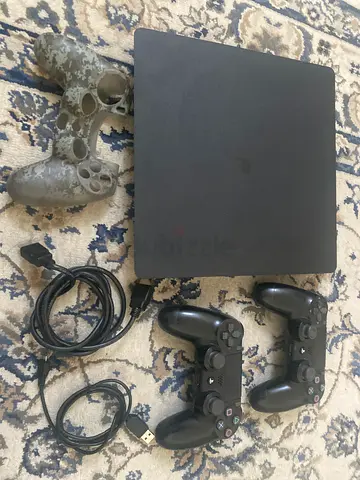 PlayStation 4 Slim with 2 controllers, extra controller and cables and controller skin