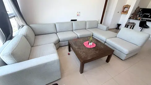 Light grey modular U-shaped fabric sofa set with ottoman (8-seater) with center table