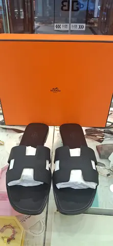 Hermès Oran-style black leather slides with orange box (preowned)