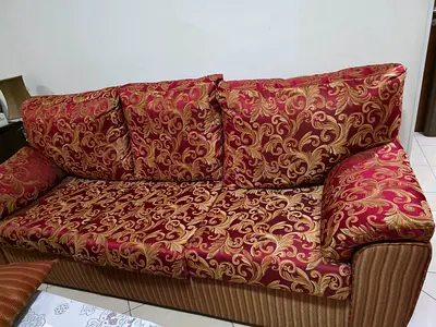 Three-seater patterned fabric sofa in red and gold — used