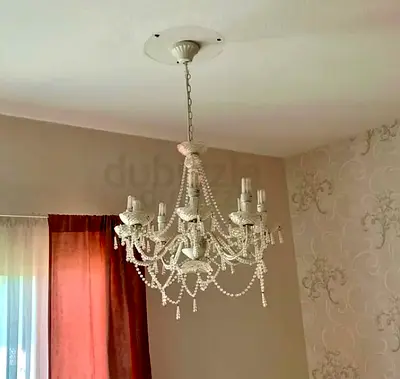 White color chandelier with the bulbs