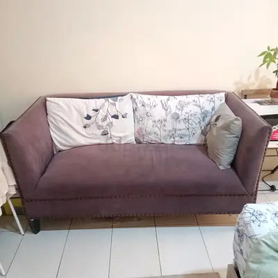 Compact two-seater upholstered sofa in mauve — good condition