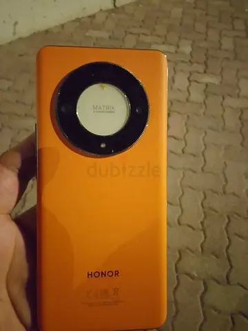 Honor smartphone with circular camera module - orange back cover