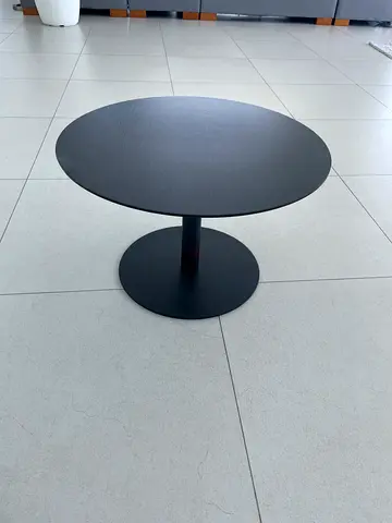 Round black coffee table with pedestal base - modern minimalist