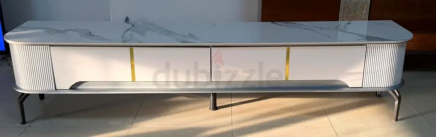 Modern white TV cabinet with marble top and gold accents