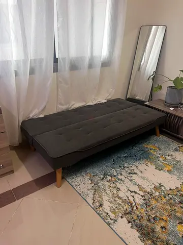 Compact dark gray single daybed/sofa bed with wooden legs