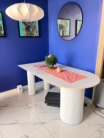 Semi circular white dining table with metal round legs