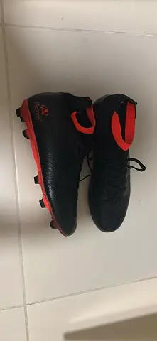Black and red mens football (soccer) cleats - good condition. Size 44