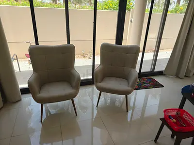 Pair of beige upholstered lounge chairs — home centre 5 months old