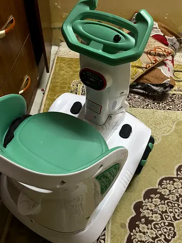 Used baby ride-on walker/rocker with steering handle - green/white