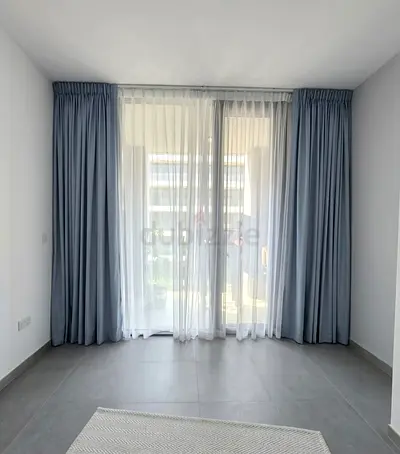Light blue blackout curtains with white sheer panels