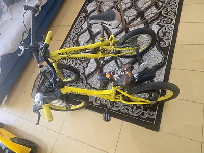 Pair of small yellow kids bicycles - good working condition