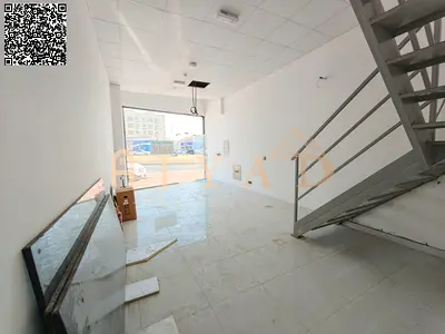 New shop with mezzanine for annual rent in Al Mowaihat 3, Ajman. Spacious, on main road, suitable for all activities, near services, easy Dubai exit.