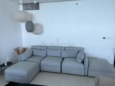 Light grey modular sectional sofa with ottoman