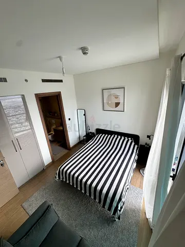 A clean double bed, mattress pad, bed frame, two bedside tables. all IKEA.