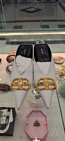 White pointed-toe Balenciaga flats with gold buckle, size unmarked