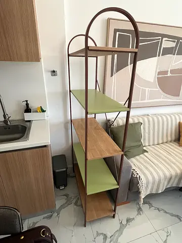 Modern open shelving unit with wood and green shelves