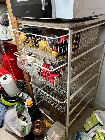 Metal storage rack with pull-out wire baskets — used