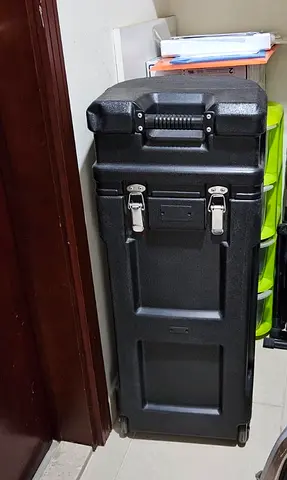 Sturdy plastic storage trunk on wheels + banner frame pieces. Also ideal for storing tools/supplies