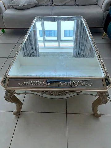 Ornate mirrored coffee table with carved legs