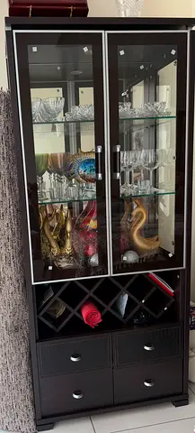 Dark Wood Display Cabinet with Glass Doors, Shelves and bottle rack.