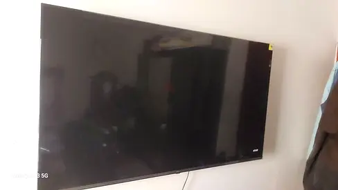 48–55 inch LED TV in good working condition (wall-mounted)