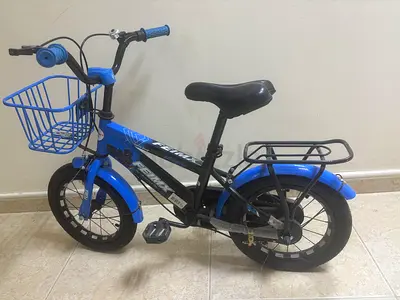 Blue kids bicycle with front basket and rear carrier — good condition