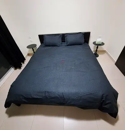 Queen-size bed frame with mattress curtains and side tables