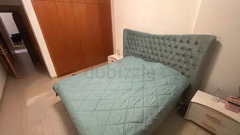 Light teal upholstered California king size bed with tufted headboard - excellent condition