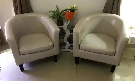 Pair of beige faux leather tub chairs - good condition