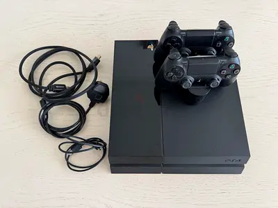 Sony PlayStation 4 (PS4) console with 2 controllers and cables