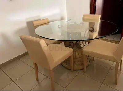 Round Glass Dining Table with 4 Beige Upholstered Chairs