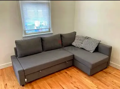 Gray L-shaped Sofa with Storage and Pull-out Bed - Good Condition