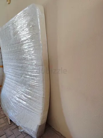 Queen mattress wrapped and ready — good condition