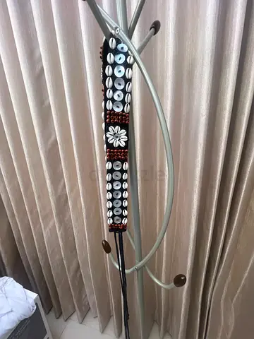 Brown beaded belt with shell and floral detailing — gently used