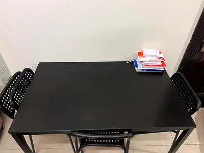 IKEA black dining table with 4 matching chairs - good condition