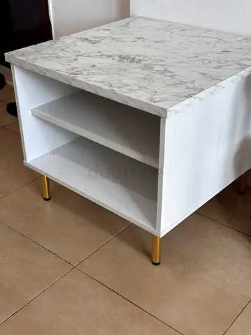 Small white bedside table with marble top and gold legs